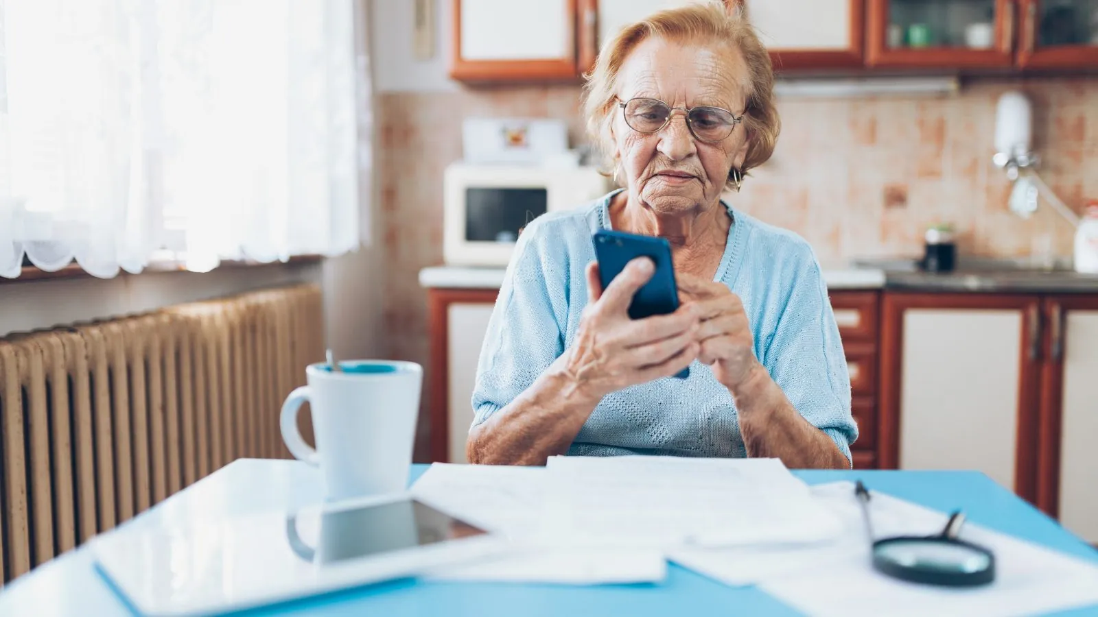 Older Woman sat at table